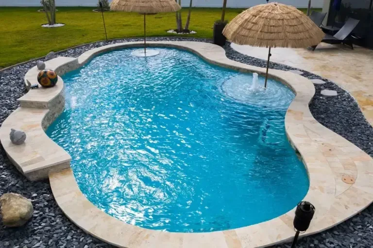 Backyard pool with travertine deck kept crystal clear by Endless Blue Pools